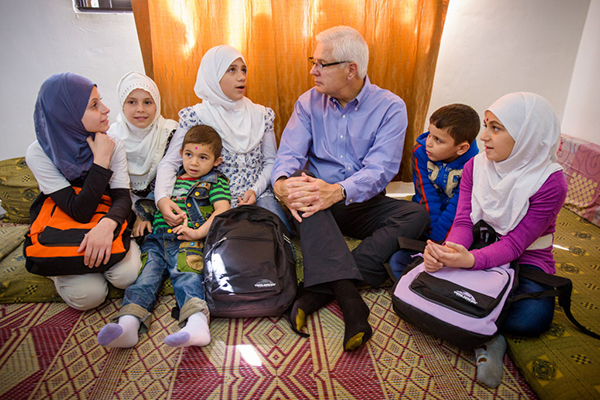 (RNS1-March24) World Vision's U.S. President Rich Stearns, center, visits with Syrian refugees in Irbid, Jordan. For use with RNS-WORLD-VISION, transmitted on March 24, 2014, Photo by Jon Warren, courtesy of World Vision.