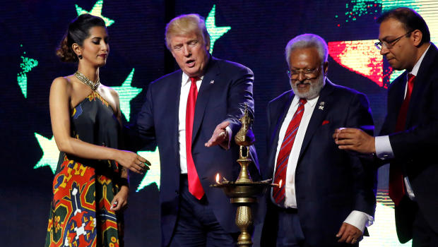 Republican presidential nominee Donald Trump enlists the help of Republican Hindu Coalition Chairman Shalli Kumar to light a ceremonial diya lamp in Edison, New Jersey